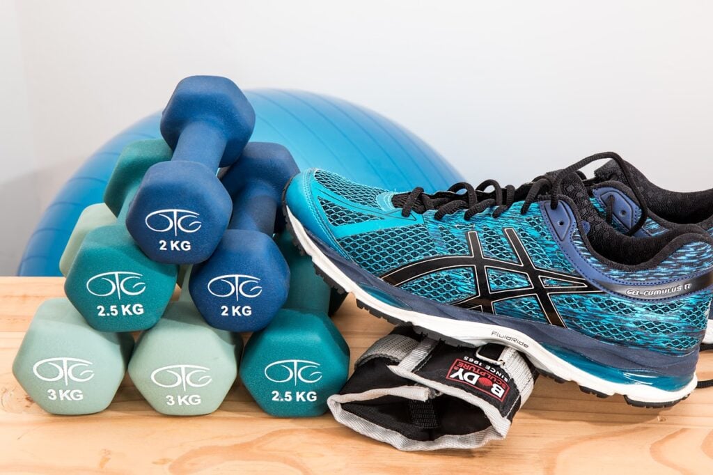 High-quality running shoes and dumbbells laid out as essential running accessories for performance and training.