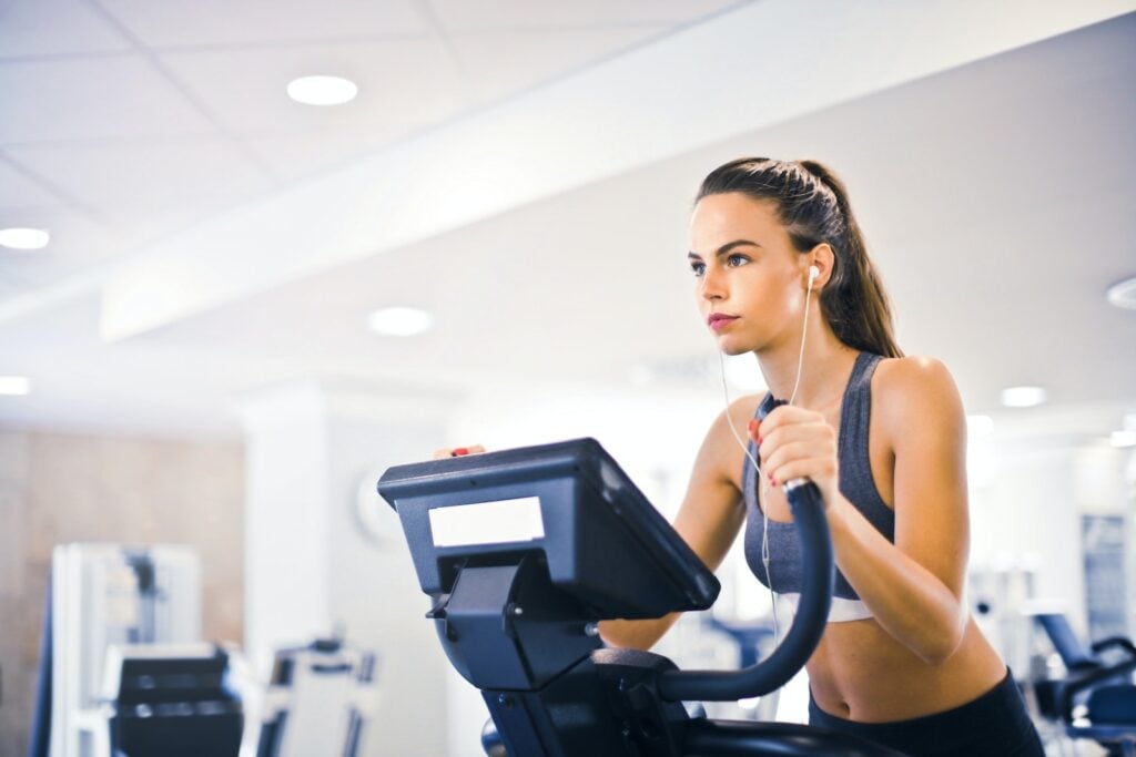 Woman exercising on an elliptical machine for targeted muscle engagement