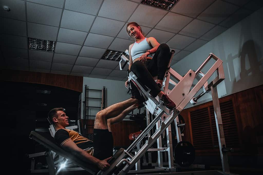 Man using leg press machine in gym