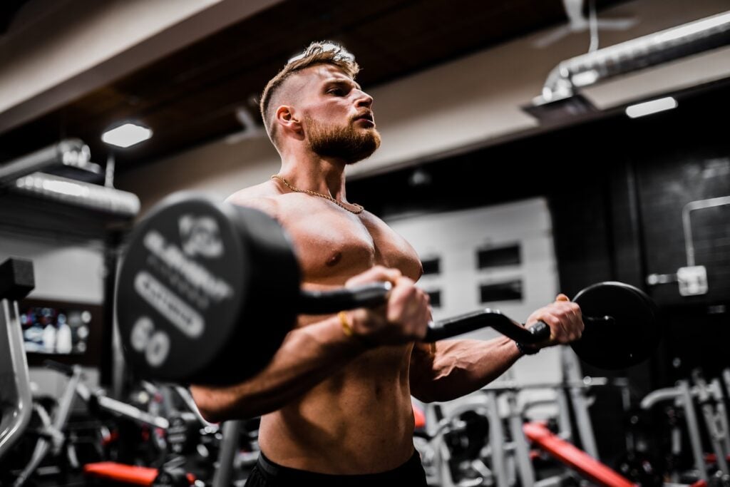 Man performing dumbbell curl for bicep workout