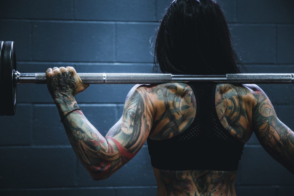 woman carrying barbell