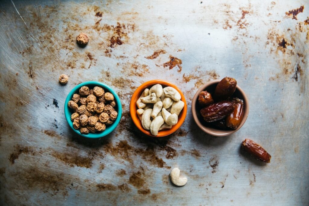 Assorted nuts in a bowl, symbolizing healthy snacking options for fitness