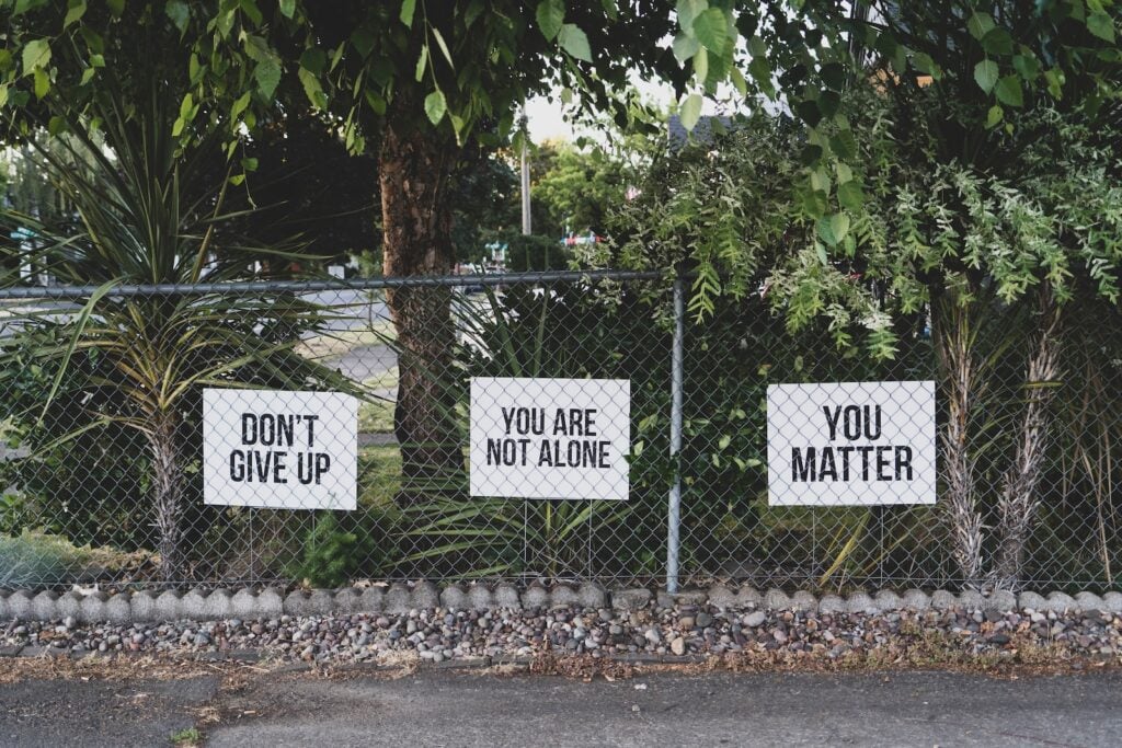 Running path with motivational signs saying 'Don't Give Up' and 'You Matter