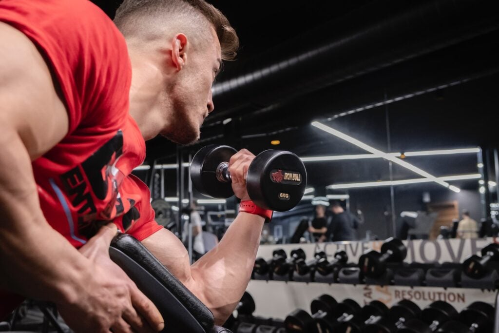 Man performing a Single Arm Preacher Curl with a dumbbell