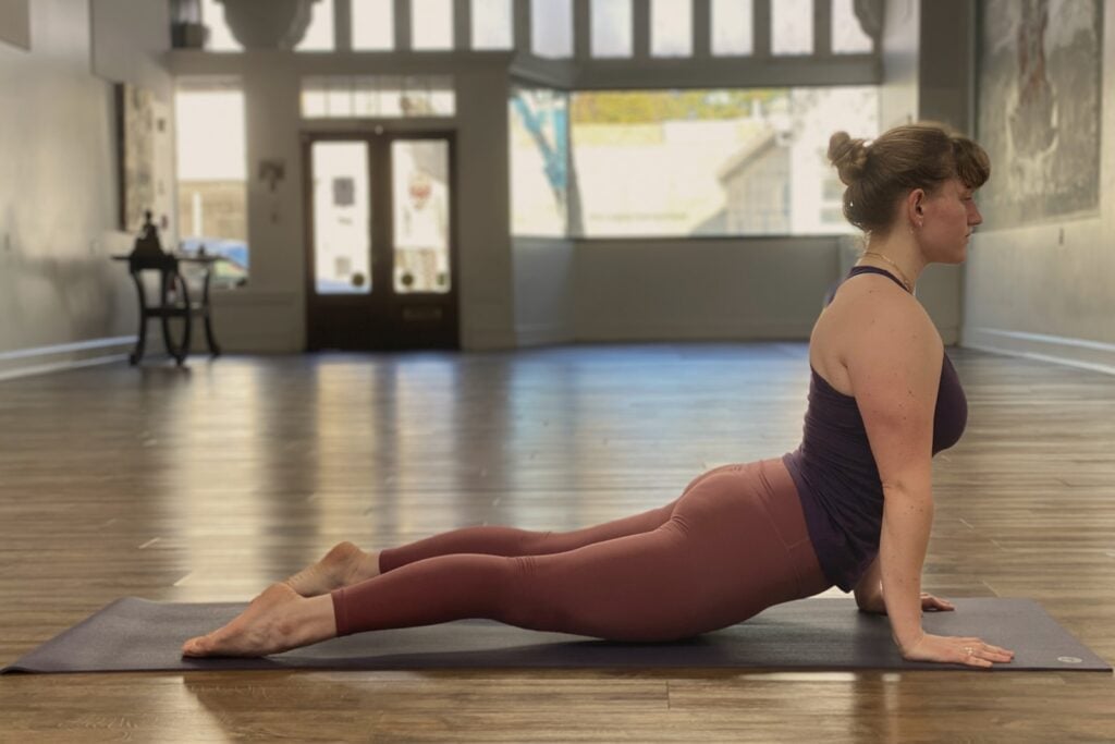 Woman practicing yoga in a serene studio setting