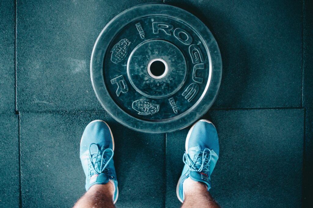 Athlete performing a deadlift, symbolizing the mastery of the Big Three exercises.