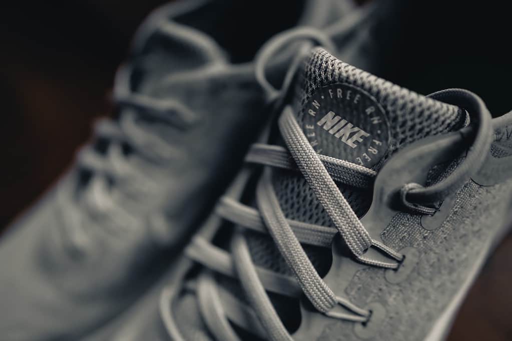 Pair of gym shoes on a workout mat, symbolizing the importance of choosing the right footwear for workouts