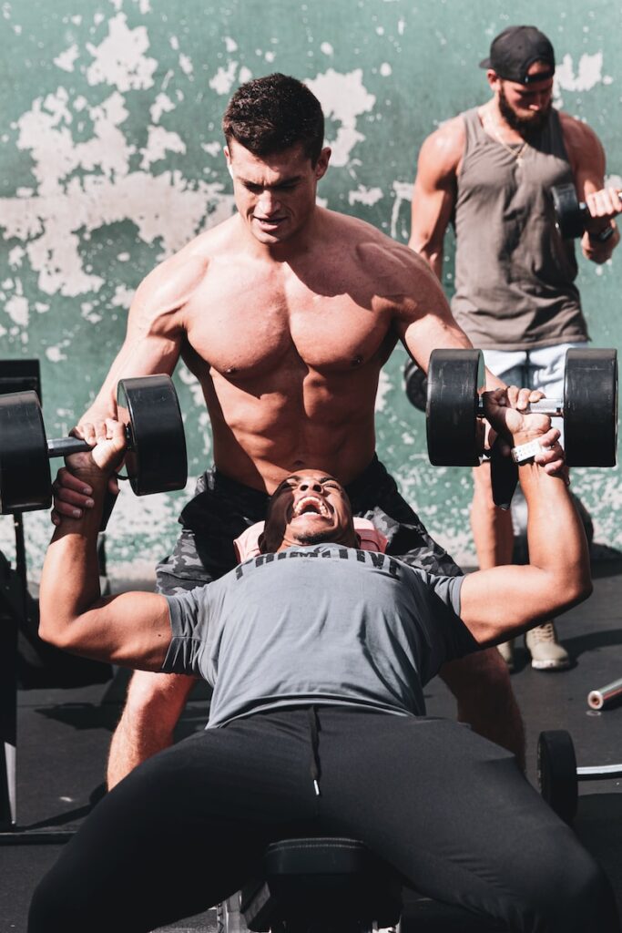 Man performing incline dumbbell press for upper chest workout