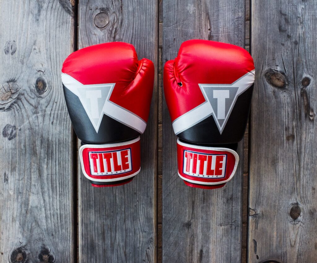 Boxing gloves and training equipment laid out, symbolizing the comprehensive guide on Boxing Fundamentals.