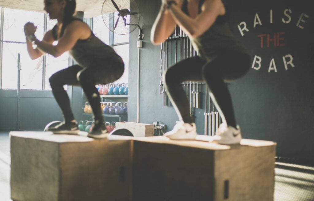 Person performing perfect form isometric squat in gym setting