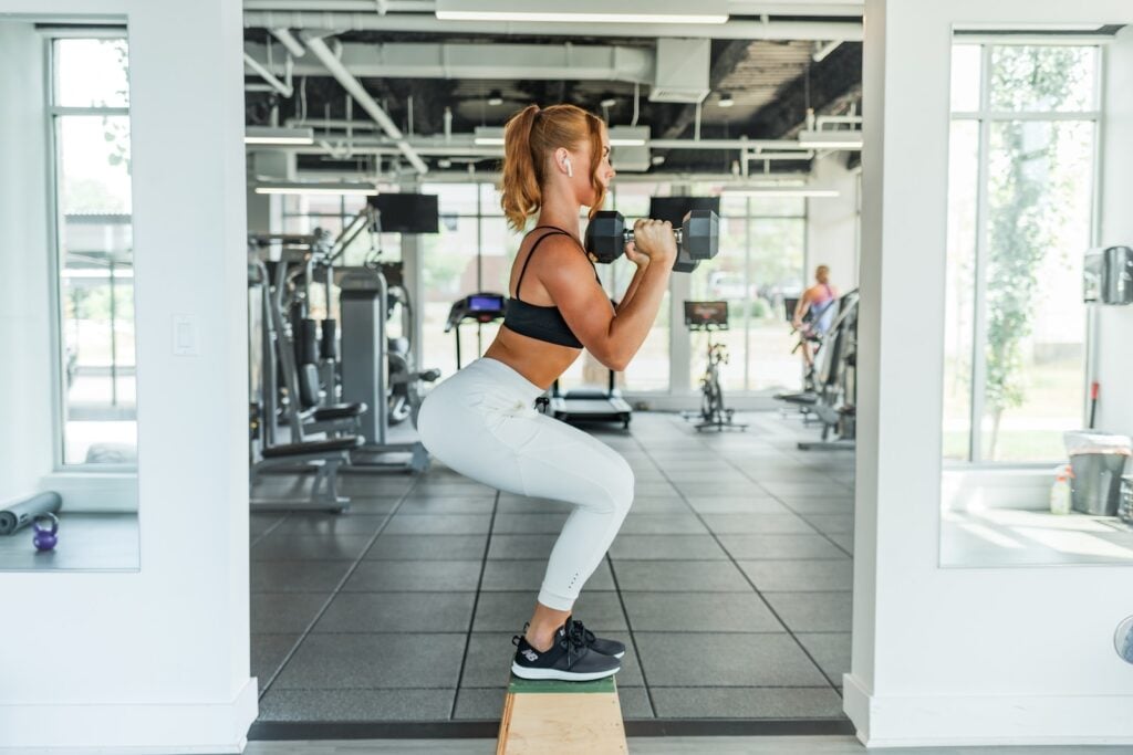 Athlete performing a deep squat with excellent form, emphasizing leg and core engagement.